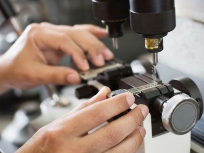 Experienced locksmith diagnosing worn commercial door lock with precision hand tools. Locksmith near me.