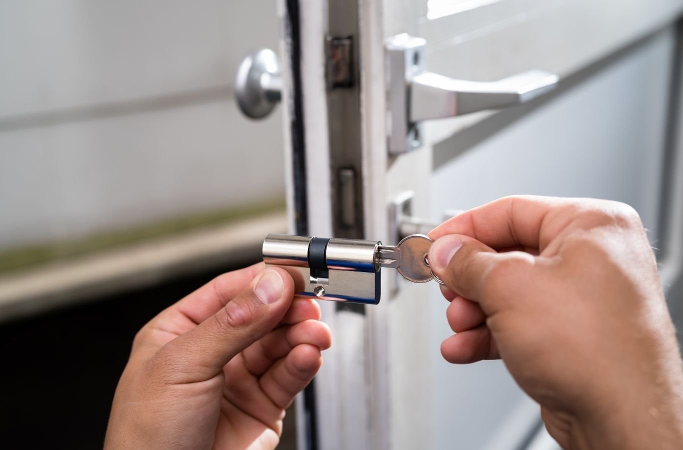 Skilled locksmith testing rekeyed deadbolt and checking door alignment on-site. Locksmith near me.